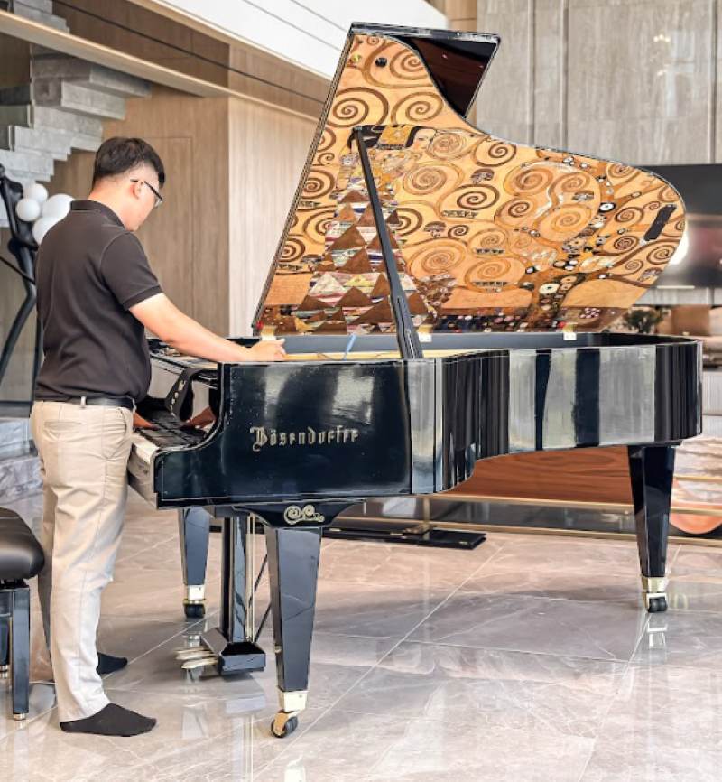 Hình ảnh nhân viên của Piano Đức Trí sửa đàn và bảo trì đàn tại nhà cho khách ở TPHCM